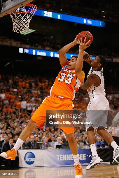Brian Williams of the Tennessee Volunteers pulls down a rebound against Durrell Summers of the Michigan State Spartans during the midwest regional...