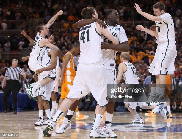 : Draymond Green, Garrick Sherman and the res of the Michigan State Spartans celebrate the win over Tennessee during the midwest regional final of...