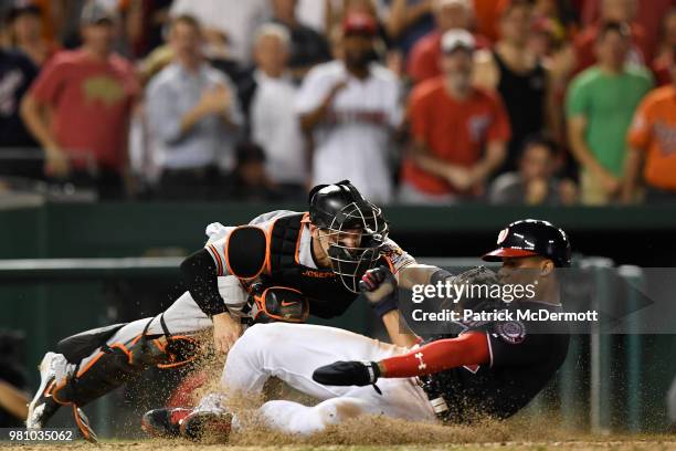 Juan Soto of the Washington Nationals is safe at home plate as he avoids the tag of Caleb Joseph of the Baltimore Orioles in the seventh inning at...