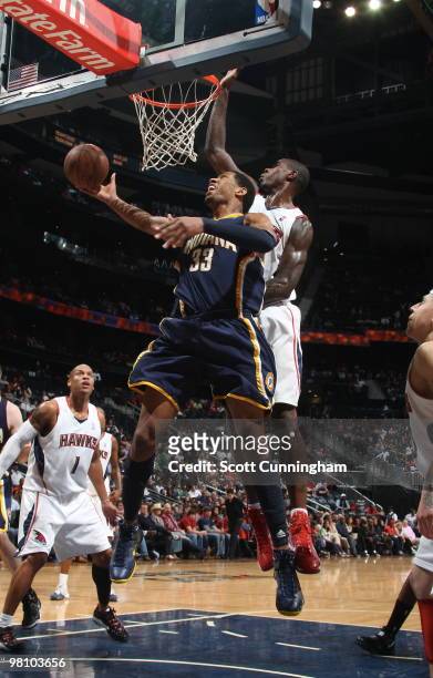 Danny Granger of the Indiana Pacers puts up a shot against Marvin Williams of the Atlanta Hawks on March 28, 2010 at Philips Arena in Atlanta,...