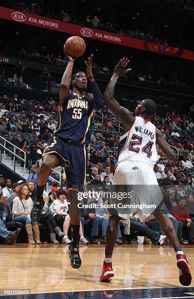 Roy Hibbert of the Indiana Pacers puts up a shot against Marvin Williams of the Atlanta Hawks on March 28, 2010 at Philips Arena in Atlanta, Georgia....