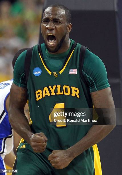 Forward Quincy Acy of the Baylor Bears reacts after making a slam dunk against the Duke Blue Devils during the south regional final of the 2010 NCAA...