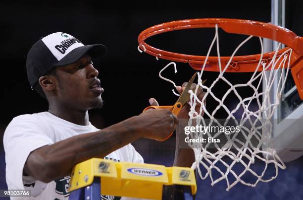 Durrell Summers of the Michigan State Spartans cuts a piece of the net after the win over the Tennessee Volunteers during the midwest regional final...