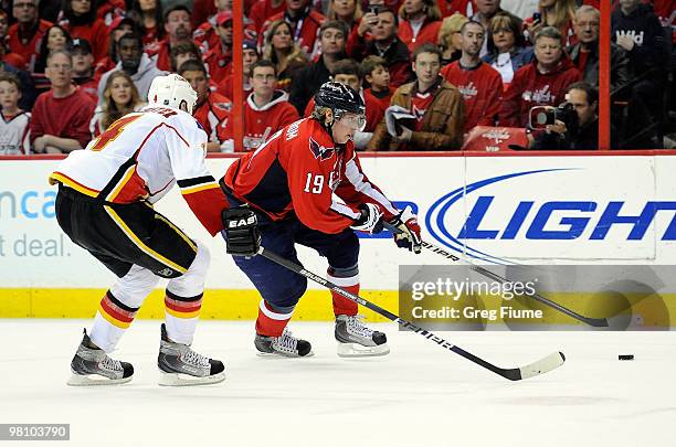 Nicklas Backstrom of the Washington Capitals handles the puck against Jay Bouwmeester of the Calgary Flames at the Verizon Center on March 28, 2010...