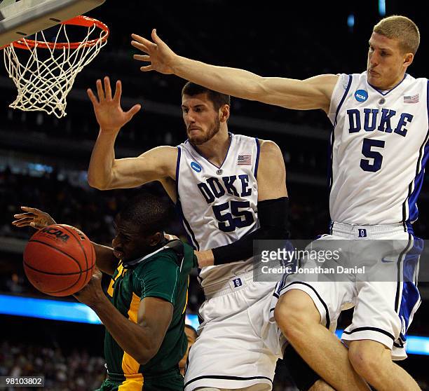 Ekpe Udoh of the Baylor Bears is fouled as he tries to shoot under pressure from Brian Zoubek and Mason Plumlee of the Duke Blue Devils during the...