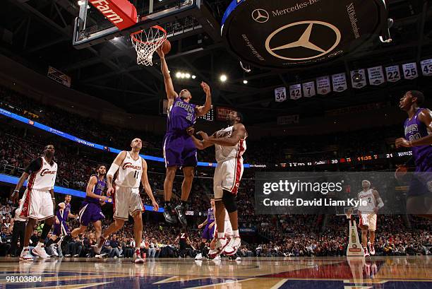 Ime Udoka of the Sacramento Kings lays in the shot defended by Zydrunas Ilgauskas and Leon Powe of the Cleveland Cavaliers on March 28, 2010 at The...