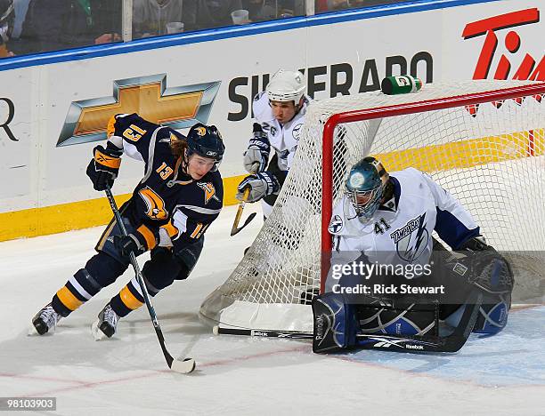 Tim Kennedy of the Buffalo Sabres cuts around the net as Martin St. Louis and Mike Smith of the Tampa Bay Lightning defend at HSBC Arena on March 27,...