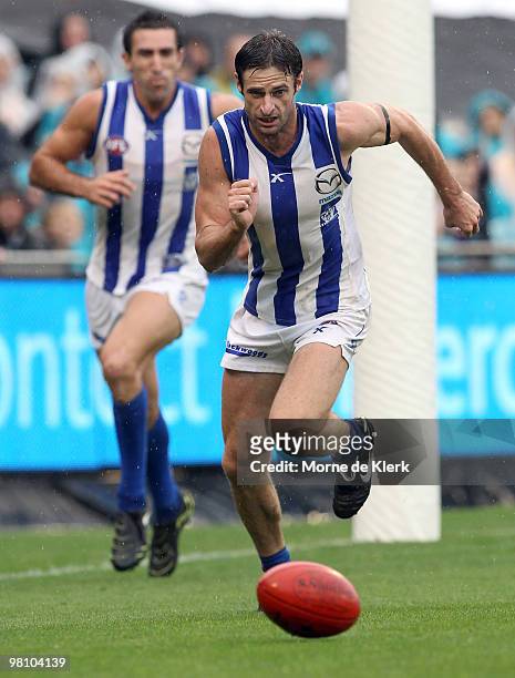 Brady Rawlings of the Kangaroos chaese the ball during the round one AFL match between the Port Adelaide Power and the North Melbourne Kangaroos at...