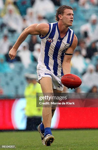 Lachlan Hansen of the Kangaroos hand balls during the round one AFL match between the Port Adelaide Power and the North Melbourne Kangaroos at AAMI...