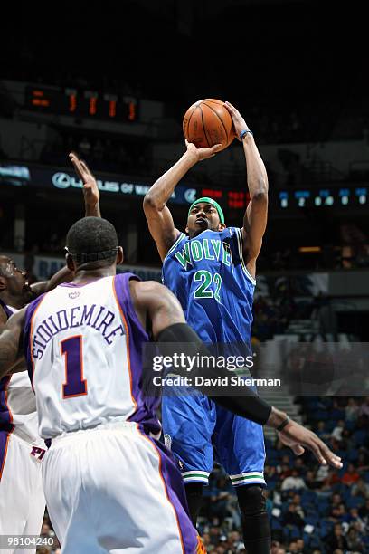 Corey Brewer of the Minnesota Timberwolves shoots against Grant Hill and Amar'e Stoudemire of the Phoenix Suns during the game on March 28, 2010 at...