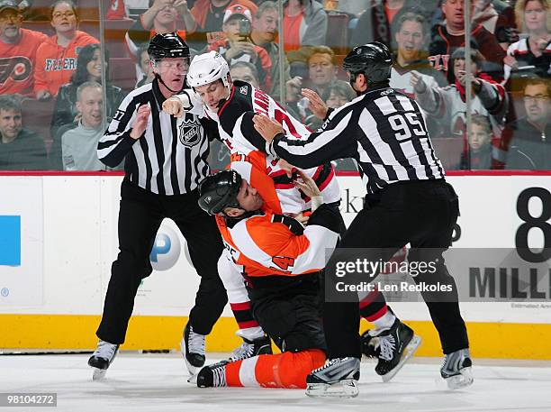 David Clarkson of the New Jersey Devils takes down Ian Laperriere of the Philadelphia Flyers in a first-period fight on March 28, 2010 at the...
