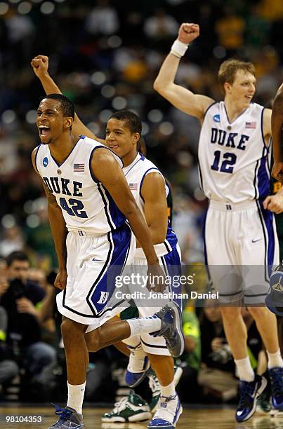 Lance Thomas, Andre Dawkins and Kyle Singler of the Duke Dlue Devils celebrate a win over the Baylor Bears during the south regional final of the...