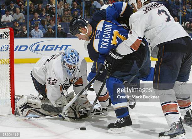 Devan Dubnyk and Aaron Johnson of the Edmonton Oilers defend against Keith Tkachuk of the St. Louis Blues on March 28, 2010 at Scottrade Center in...