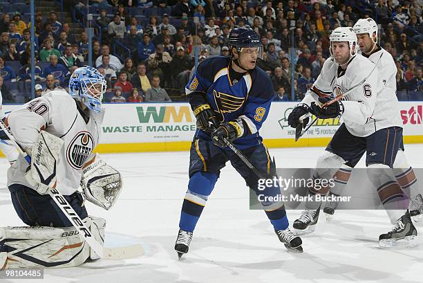 Devan Dubnyk and Ryan Whitney of the Edmonton Oilers defend against Paul Kariya of the St. Louis Blues on March 28, 2010 at Scottrade Center in St....