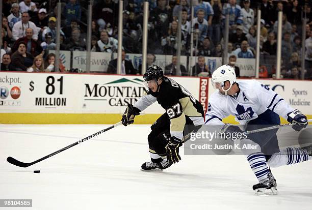 Sidney Crosby of the Pittsburgh Penguins skates in behind Francois Beauchemin of the Toronto Maple Leafs in the overtime period at Mellon Arena on...