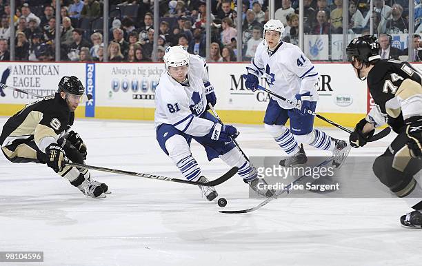 Phil Kessel of the Toronto Maple Leafs skates between the defense of Pascal Dupuis and Jay McKee of the Pittsburgh Penguins on March 28, 2010 at...