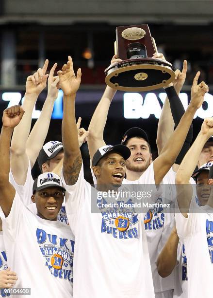 The Duke Blue Devils hold up the trophy after a 78-71 win against the Baylor Bears during the south regional final of the 2010 NCAA men's basketball...