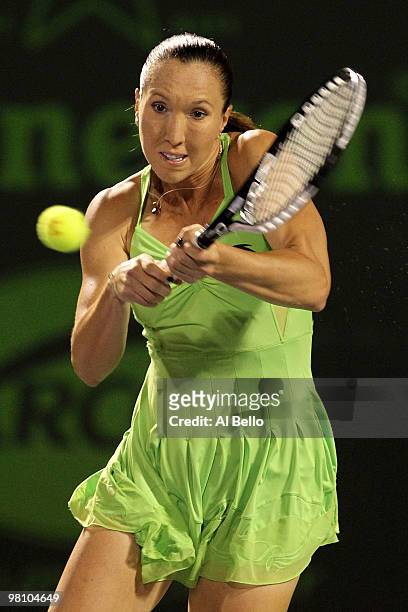 Jelena Jankovic of Serbia returns a shot against Elena Vesnina of Russia during day six of the 2010 Sony Ericsson Open at Crandon Park Tennis Center...