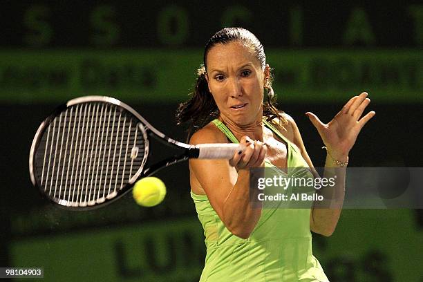 Jelena Jankovic of Serbia returns a shot against Elena Vesnina of Russia during day six of the 2010 Sony Ericsson Open at Crandon Park Tennis Center...