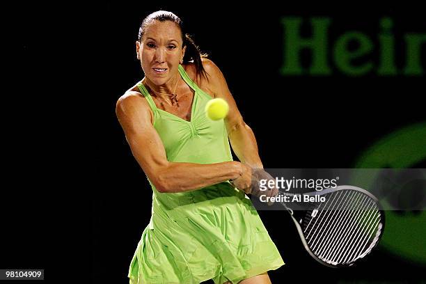 Jelena Jankovic of Serbia returns a shot against Elena Vesnina of Russia during day six of the 2010 Sony Ericsson Open at Crandon Park Tennis Center...