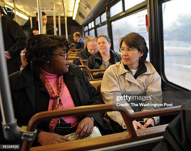 While riding on a bus from the Wiehle Park & Ride to the West Falls Church Metro Station, Deloris Bailey talks with rider Lina Patino on March 25,...