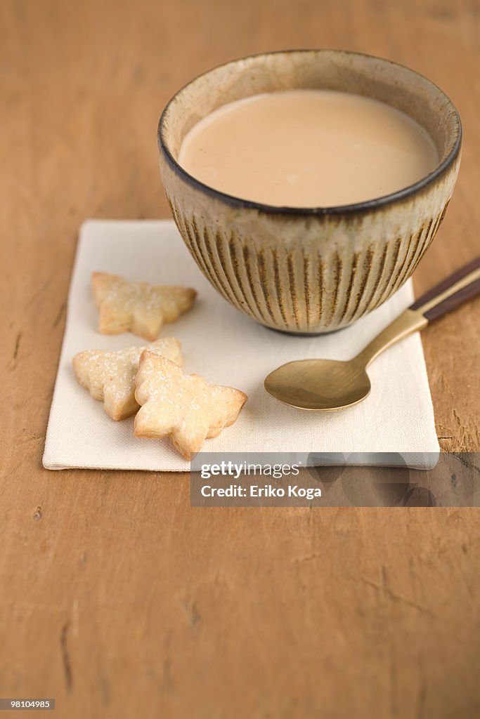 Ginger cookie shaped of butterfly with cup of chai