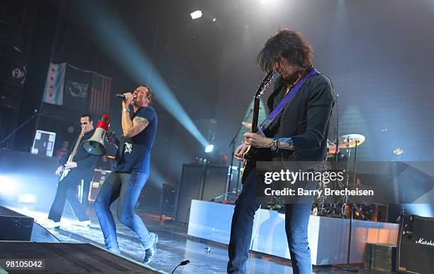 Bassist Robert DeLeo, singer Scott Weiland and guitartist Dean DeLeo of Stone Temple Pilots perform at the Riviera Theatre on March 27, 2010 in...