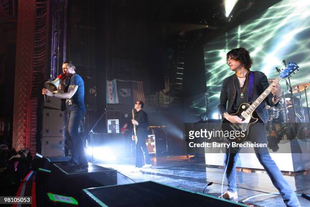 Singer Scott Weiland, bassist Robert DeLeo and guitartist Dean DeLeo of Stone Temple Pilots perform at the Riviera Theatre on March 27, 2010 in...