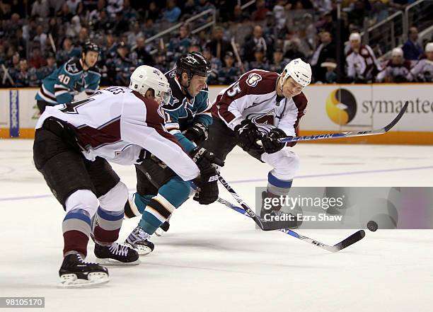 Scott Nichol of the San Jose Sharks skates between John-Michael Liles and Matt Hendricks of the Colorado Avalanche at HP Pavilion on March 28, 2010...