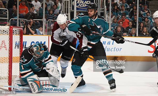 Cody McLeod of the Colorado Avalanche battles for the puck with Niclas Wallin and Thomas Greiss of the San Jose Sharks during an NHL game on March...