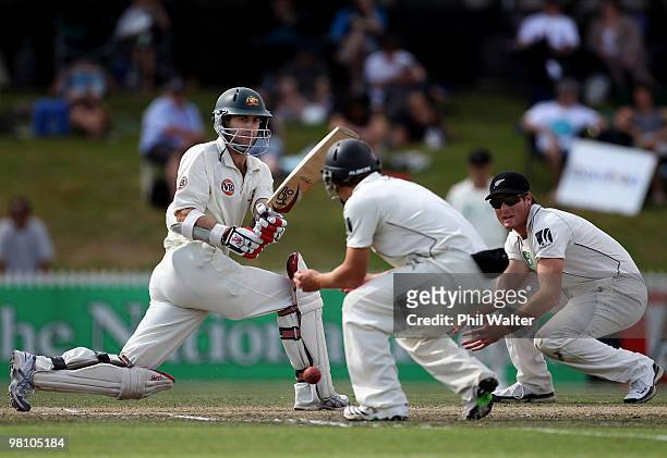 Simon Katich of Australia bats the ball past BJ Watling and Martin Guptill of New Zealand during day three of the Second Test Match between New...