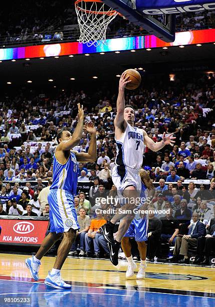 Redick of the Orlando Magic drives against Malik Allen of the Denver Nuggets during the game at Amway Arena on March 28, 2010 in Orlando, Florida....