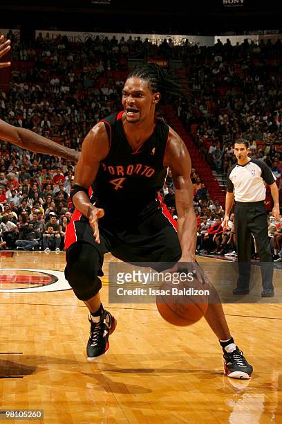 Chris Bosh of the Toronto Raptors drives against Joel Anthony of the Miami Heat on March 28, 2010 at American Airlines Arena in Miami, Florida. NOTE...