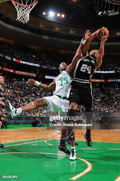 Richard Jefferson of the San Antonio Spurs grabs a rebound against Shelden Williams of the Boston Celtics on March 28, 2010 at the TD Garden in...