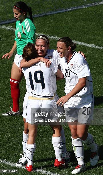 Lauren Cheney is congratulated by teammates Kelley O'Hara and Abby Wambach of the USA following Cheney's goal during the Women's International...