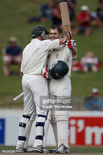 Simon Katich of Australia celebrates his century with Michael Hussey during day three of the Second Test Match between New Zealand and Australia at...