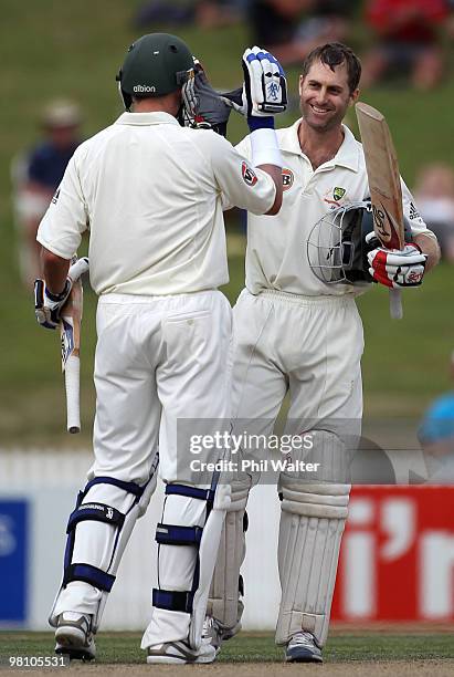 Simon Katich of Australia celebrates his century with Michael Hussey during day three of the Second Test Match between New Zealand and Australia at...