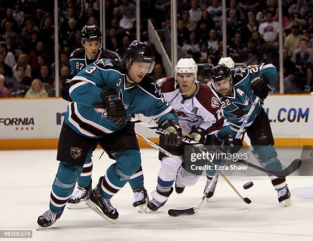 Dan Boyle, Douglas Murray and Manny Malhotra of the San Jose Sharks keeps the puck away from Paul Stastny of the Colorado Avalanche at HP Pavilion on...