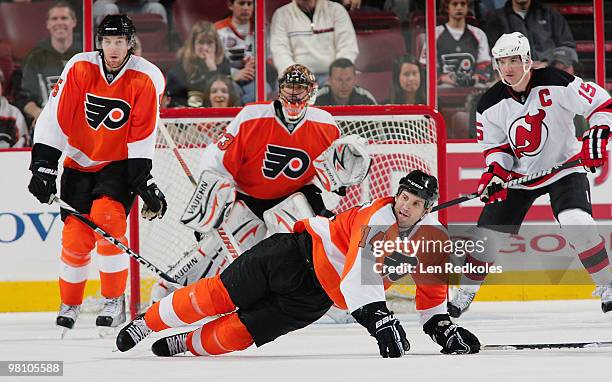 Ian Laperriere of the Philadelphia Flyers dives to block a shot from a member of the New Jersey Devils in front of goaltender Brian Boucher on March...