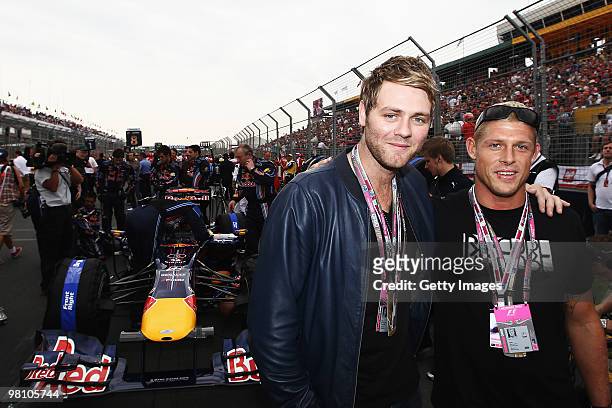 Australian professional surfer Mick Fanning and singer Brian Mcfadden are seen on the grid before the Australian Formula One Grand Prix at the Albert...