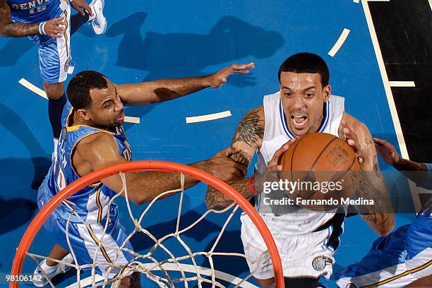 Matt Barnes of the Orlando Magic takes the ball to the basket against Malik Allen of the Denver Nuggets during the game on March 28, 2010 at Amway...