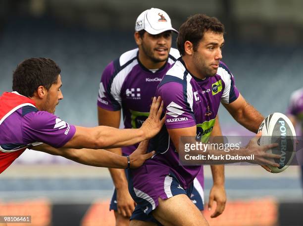 Cameron Smith of the Storm looks to give off a pass during a Melbourne Storm NRL training session at Princes Park on March 29, 2010 in Melbourne,...