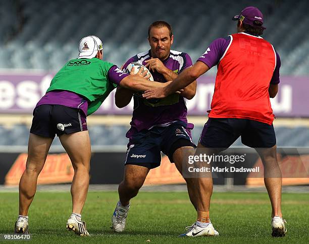 Ryan Tandy of the Storm is tackled during a Melbourne Storm NRL training session at Princes Park on March 29, 2010 in Melbourne, Australia.