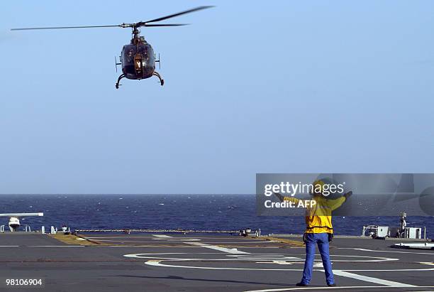 Picture taken on March 23 shows an helicopter landing on French helicopter-carrier Jeanne d'Arc, en route from the French Caribbean island of La...