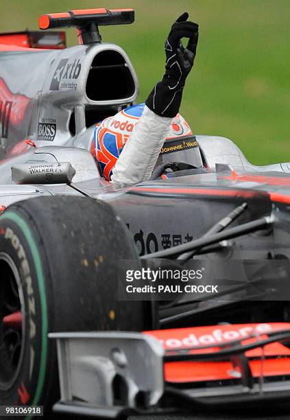 McLaren-Mercedes driver and reigning world champion Jensen Button of Britain waves to the crowd after winning Formula One's Australian Grand Prix in...