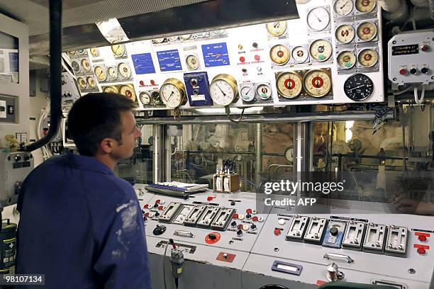 French sailor works in a command center on March 22 on bard of French helicopter-carrier Jeanne d'Arc, en route from the French Caribbean island of...