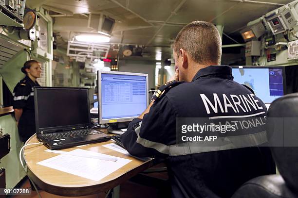 French Marine soldiers work on March 22 in the command center of French helicopter-carrier Jeanne d'Arc, en route from the French Caribbean island of...