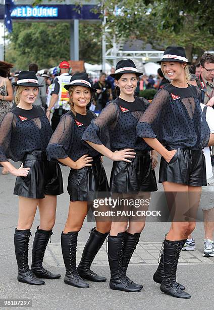 Promotion girls pose for a photo as they prepare ahead of Formula One's Australian Grand Prix in Melboune on March 28, 2010. AFP PHOTO/Paul CROCK