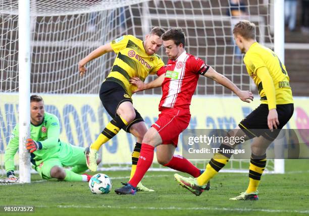 Goalkeeper Michael Rensing of Fortuna Duesseldorf, Patrick Mainka and Jannik Schneider of Fortuna Duesseldorf and Amos Pieper of Dortmund II battle...