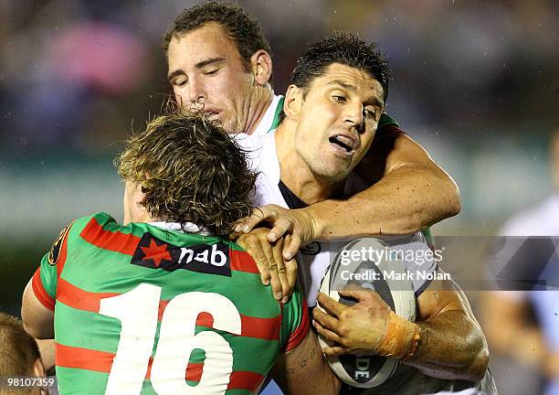 Trent Barrett of the Sharks is tackled during the round three NRL match between the Cronulla Sharks and the South Sydney Rabbitohs at Toyota Stadium...